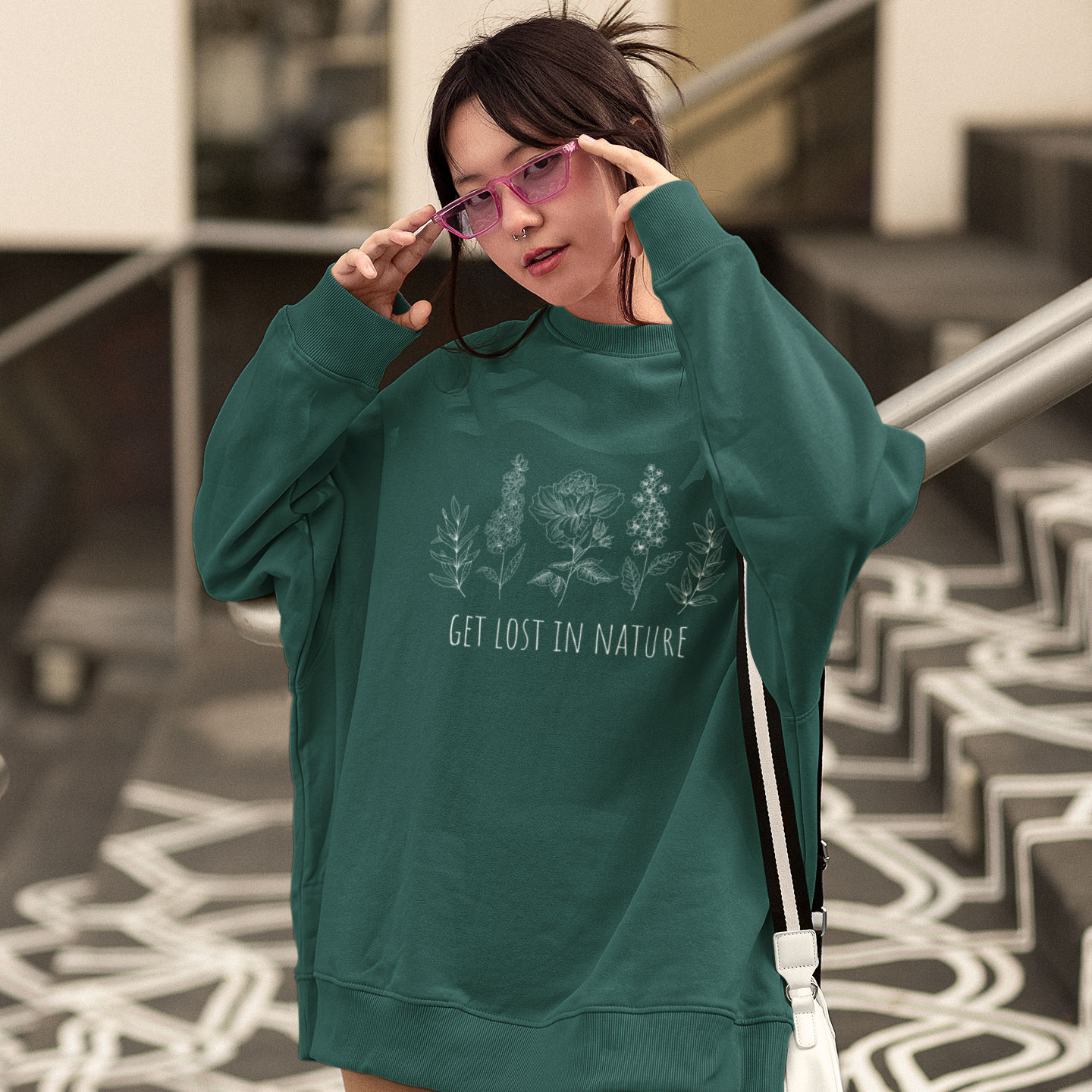 Person wearing a green sweatshirt with text, standing on a patterned floor.