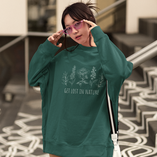 Person wearing a green sweatshirt with text, standing on a patterned floor.